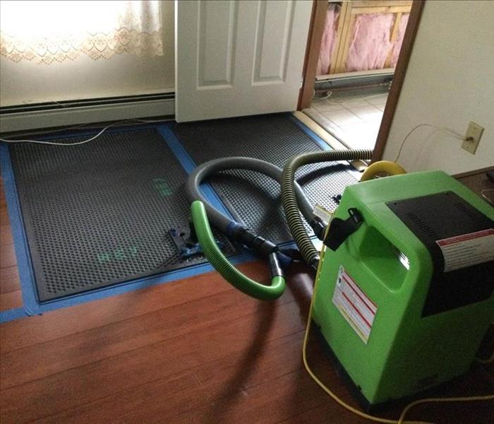Drying mats on floor in doorway.